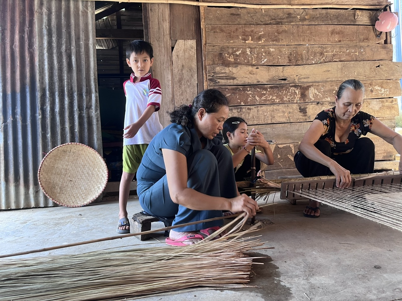 Nhờ sự tuyên truyền, vận động của già làng, Người có uy tín, bà con Buôn Trấp, xã Krông Ana quan tâm gìn giữ nghề đan chiếu truyền thống (trong ảnh: Bà Ae Tul Pa và Mí Pa chuẩn bị nguyên liệu, khung đan để phục hồi nghề xưa)