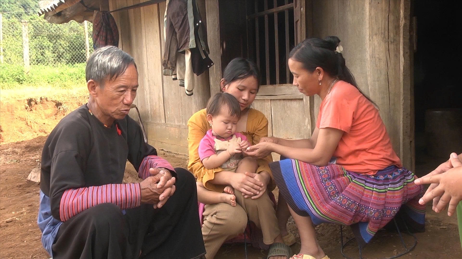Già làng Sùng A Dếnh trò chuyện, thăm hỏi và tuyên truyền, vận động gia đình người Mông chăm sóc trẻ nhỏ, xây dựng cuộc sống ấm no, tiến bộ