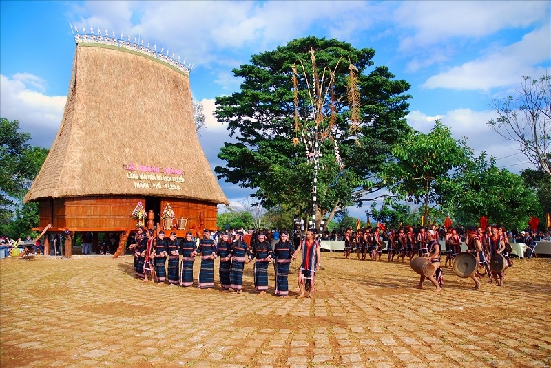 The Gia-rai people, Op village perform gong music next to their traditional communal house