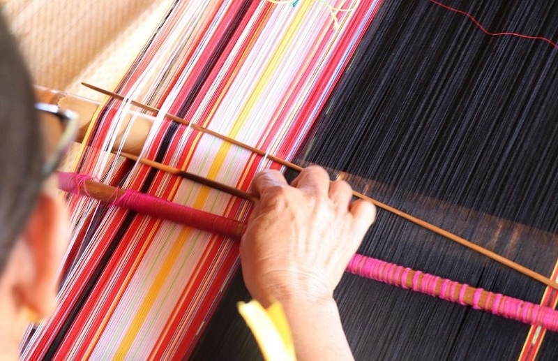 The Gia-rai women meticulously work at their rudimentary looms to create unique brocade fabrics.