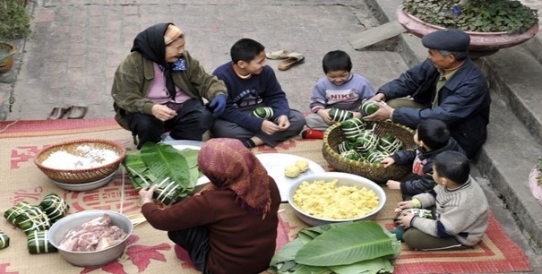 A Nung family gathers to wrap chung cake (traditional Vietnamese rice cakes) in preparation for the traditional Lunar New Year