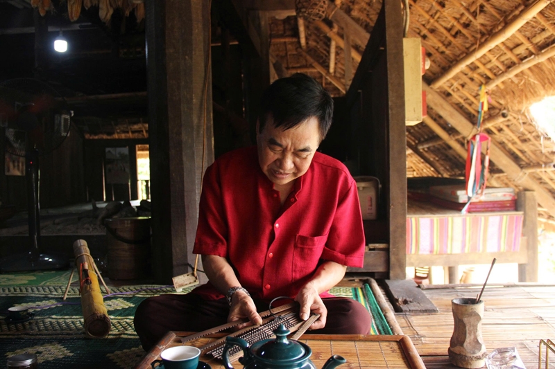Nghệ nhân Đinh Ngọc Lương xem Lịch Đoi (Lịch Tre) - bộ lịch cổ truyền độc đáo của người Mường, được làm từ 12 thẻ tre tượng trưng cho 12 tháng, ghi chép ngày, tháng, thời tiết và dự đoán cát - hung. 