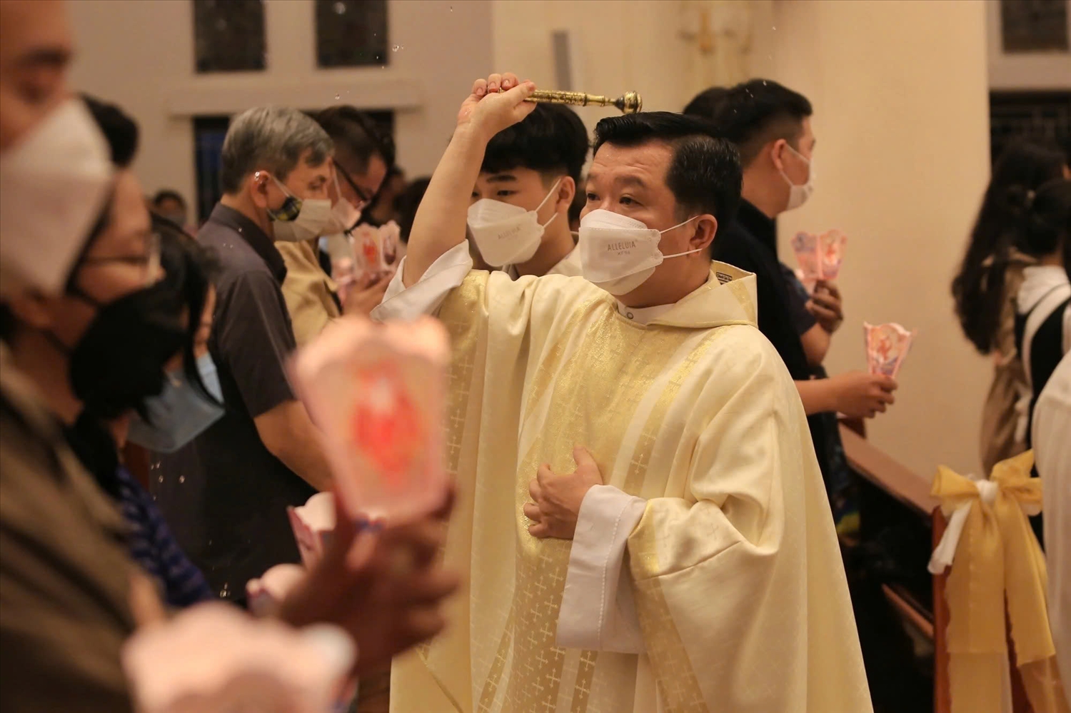 A priest sprinkles holy water during the Easter service