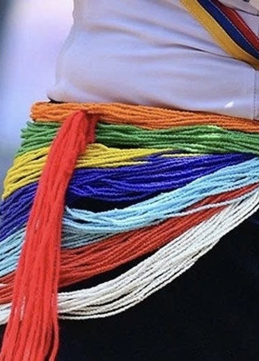 Beaded jewelry on the traditional clothing of Cor ethnic girls 